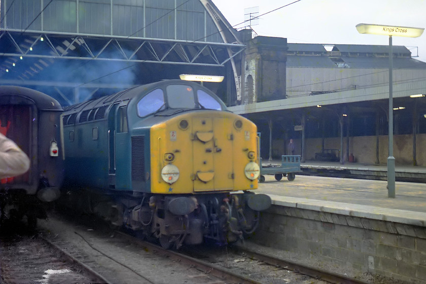 40057, down football special, London Kings Cross station 
 40057 leaves King's Cross with a footex. I have it down as carrying Arsenal supporters, however, as they were playing Aston Villa at Highbury on this particular Saturday this information must be wrong. If anybody can help with where this football special was going I would be grateful for the information. It was spotted further up at Huntingdon so it went up the ECML at least as far as this! The glowing florescent lights give an indication as to how gloomy this day was. 
 Keywords: 40057 down football special London Kings Cross station