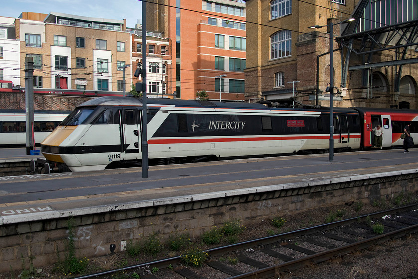 91119, GR 12.00 Edinburgh Waverley-London King`s Cross (1E14, 136L), London King`s-Cross station 
 I was beginning to think that I would never see celebrity 91119 'Bounds Green' before it would be withdrawn so, I was delighted to see it arrive at the rear of the 12.00 from Edinburgh at King's Cross. The passengers would have been extremely relieved to arrive as the service was an eye-watering one hundred and thirty-six minutes late! Many trains were late on this day due to the extreme heat causing problems throughout the network. 
 Keywords: 91119 12.00 Edinburgh Waverley-London King`s Cross 1E14 London King`s-Cross station