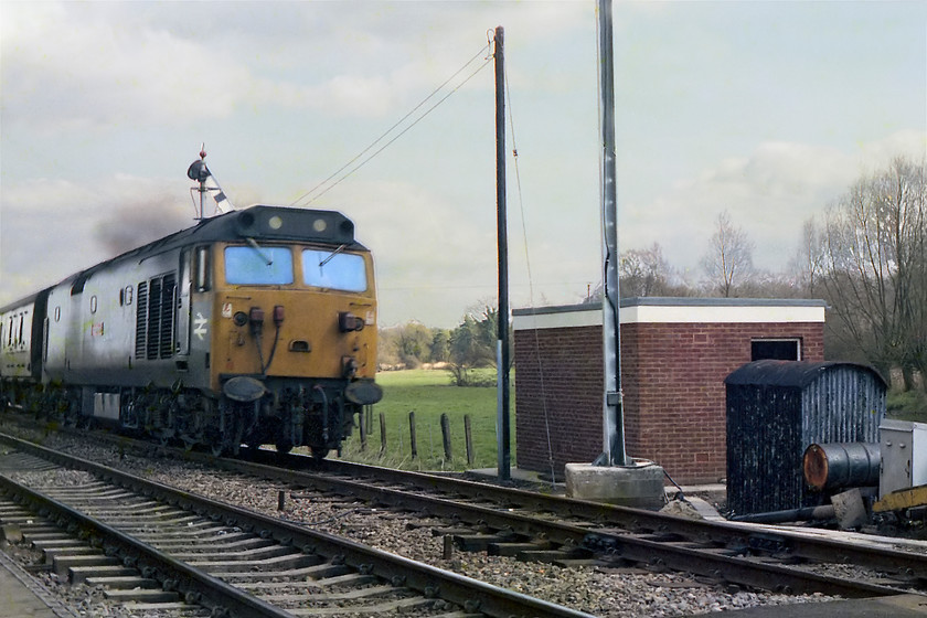 50026, unidentified down working, Hamstead crossing 
 Having worked up to London earlier in the day (seen at Bedwyn) 50026 'Indomitable' speeds past Hamstead with an unidentified down working. It is about to pass the newly built relay and control room next to the newly installed CCTV mast. The semaphore above the class 50 would only operate for a few more hours as Hamstead box, that controlled it, was being closed at midnight of this day. 
 Keywords: 50026 unidentified down working Hamstead crossing