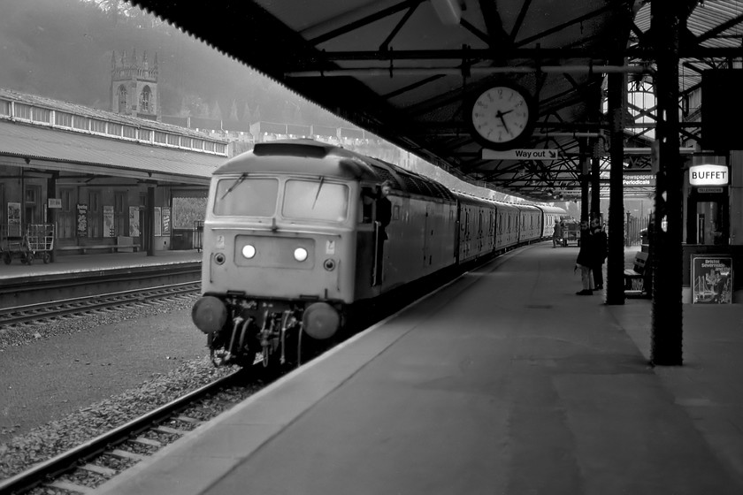 Class 47, up parcels, Bath Spa station 
 My first railway photograph with my new Pentax ME Super and it's out of focus! Normally, this would be confined to the 'almost ran' box but as its a milestone photograph for me it has made the cut! At 14.26 an unidentified Class 47 comes to a halt at Bath Spa station with a crew member ready to leap from the cab. The Post Office (now Royal Mail) staff are also ready towards the rear of the train with their trolley to load and unload mailbags. This sort of train and its associated activity is now lost from the railways but there is continued talk of its return in an effort to get trucks off the road; how very sensible that would be! 
 Keywords: Class 47 up parcels Bath Spa station