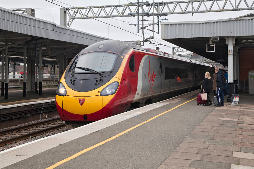 390122, VT 09.14 London Euston-Liverpool South Parkway (1F11, 29L), Nuneaton station 
 My wife and son wait as 390122 'Penny the Pendolino' comes to a halt at Nuneaton station. We would all then board this service, the 09.14 London Euston to Liverpool South Parkway, and go all the way for our short break in Liverpool. This train arrived 29 minutes late into South Parkway station where we had to experience the ignominy of being herded by Merseyrail staff on to one of their units for the trip to Liverpool Central. 
 Keywords: 390122 1F11Nuneaton station