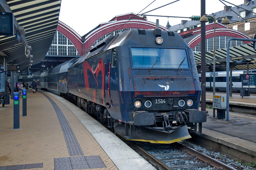 1514, 17.56 Copenhagen Central-Kalundborg, Copenhagen Central station 
 At the heart of Danish State Railways (DSB) locomotive fleet is thirty-seven Class ME Co-Co diesel electrics. Dating from the early 1980s these powerful locomotives operate throughout their network on push-pull double-decker trains. At Copenhagen Central station, 1514 will soon depart with the 17.56 to Kalundborg. Kalundborg is a town of sixteen thousand people sixty-eight miles from Copenhagen. 
 Keywords: 1514 17.56 Copenhagen Central-Kalundborg Copenhagen Central station