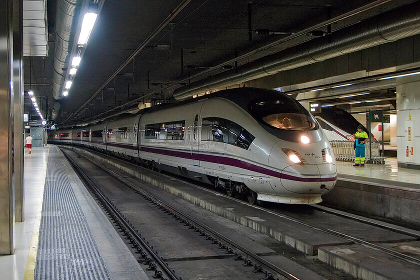 103 614, Renfe 17.30 Barcelona-Sants-Madrid Atocha, Barcelona-Sants station 
 Taken in the dark depths of Barcelona's main Sants station one of Renfe's AVE (High Speed Train) Class 103s is ready to leave working the 17.30 service to Madrid Atocha. 103 614 is one of twenty-eight train sets built from 2007 that operate on this route between Barcelona and the capital. They are capable of speeds up to over three hundred miles per hour but are severely limited by the current signalling systems. However, it still only takes two and a half hours between the two cities. 
 Keywords: 103 614 Renfe 17.30 Barcelona-Sants-Madrid Atocha Barcelona-Sants station