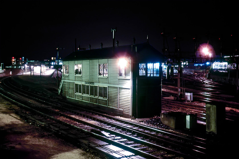 Newton Abbot West signal box (GW, 1925) 
 I took a photograph of Newton Abbot West signal box from an identical spot a few weeks previously to this one, see......https://www.ontheupfast.com/p/21936chg/29422481604/newton-abbot-west-signal-box-great However, a time exposure adds a whole new level of atmosphere to a photograph and this one is no exception. Notice the colours of the signal glasses clearly seen to the right of the dolls sitting on top of the down home gantry. 
 Keywords: Newton Abbot West signal box Great Western