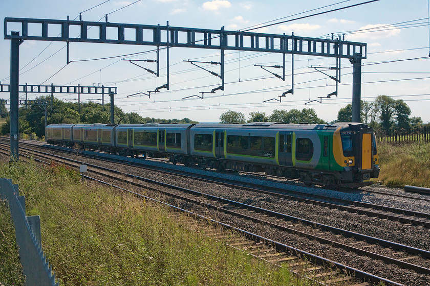 350119, LM 12.46 London Euston-Crewe (1U35), passing the TSR, Ashton Road bridge 
 350119 at walking pace passing through a temporary speed restriction between Roade and Ashton on the southern WCML. The cause of the TSR was the emergency application of fresh ballast that had yet to be tamped properly, this was done the following night, an activity that we could hear being undertaken from our house a short distance from this location. 
 Keywords: 350119 12.46 London Euston-Crewe 1U35 passing the TSR Ashton Road bridge