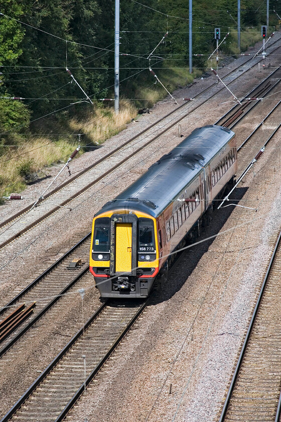 158773, EM 07.42 Liverpool Lime Street-Norwich (1L06), Westby SK962271 
 If I had used my standard lens to photograph the 07.42 Liverpool to Norwich service descending the south side of Stoke Bank it would have been completely dwarfed by the scale of the area. Therefore I have opted to utilise my rarely used 80-200mm zoom that has captured 158773 in a patch of sunshine. I have to question (again!) if a two-car DMU is appropriate for an Inter-Regional service such as this? 
 Keywords: 158773 EM 07.42 Liverpool Lime Street-Norwich 1L06 Westby SK962271 EMT East Midlands Trains