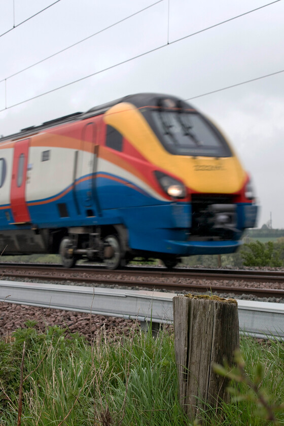 222016, EM 09.00 Sheffield-London St. Pancras (1C27, 1L) & former telegraph pole, Wymington SP946644 
 222016 speeds past Wymington on the Bedfordshire/Northamptonshire border with the 09.00 Sheffield to London St. Pancras EMR service. In the foreground is the remains of a former telegraph pole that would have been unceremoniously felled following the closure of the mechanical signal boxes on 05.12.87. 
 Keywords: 222016 09.00 Sheffield-London St. Pancras 1C27 former telegraph pole Wymington SP946644EMR East Midlands Railway Meridian