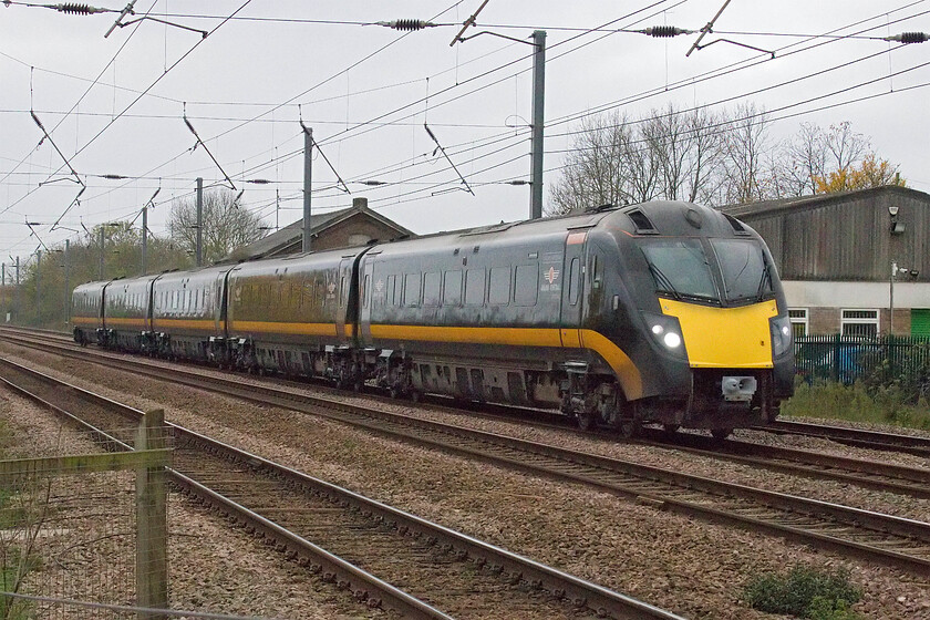 180108, GC 07.48 London King's Cross-Sunderland (1N90, 5L), Tempsford level crossing 
 Grand Central's 180108 'William Shakespeare' works the 07.48 King's Cross to Sunderland service past Tempsford. The station was located directly behind the train closing in 1956 but the goods shed still survives seen above the second coach of the Adelante. If the third section of the new East-West link ever comes to fruition, Tempsford could once again have a station with a new interchange built half a mile north of this location where the new line would cross the ECML - in my lifetime; I'm not so sure! 
 Keywords: 180108 07.48 London King's Cross-Sunderland 1N90 Tempsford level crossing Adelante Grand Central