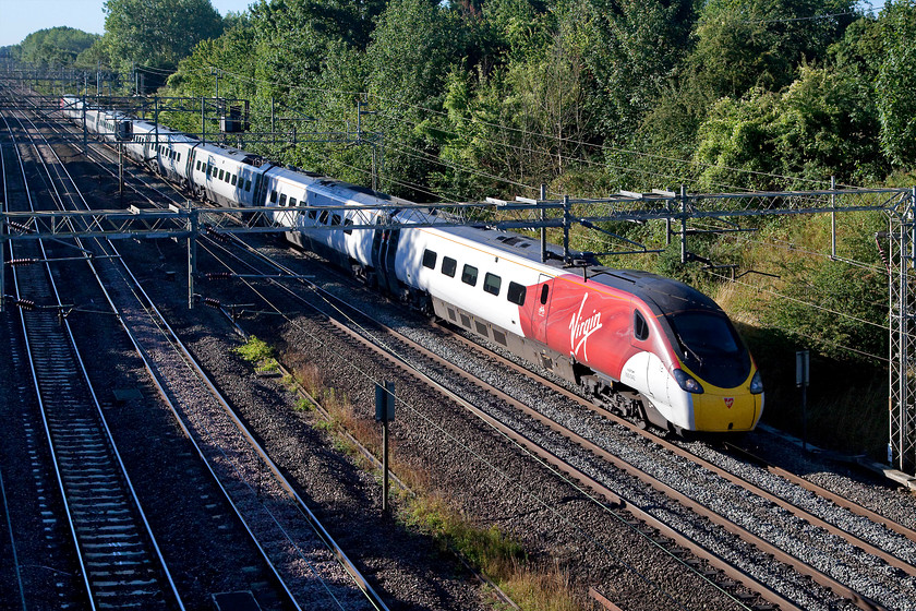 390042, VT 07.23 London Euston-Birmingham New Street (9G05, 1L), Victoria Bridge 
 With it flying silk livery looking fresh, 390042 heads north past Victoria Bridge working the 07.23 London Euston to Birmingham New Street. 390042 is now un-named previously carrying the non-matching nameplates of 'City of Bangor' and 'Dinas Bangor' on either side. 
 Keywords: 39004 9G05 Victoria Bridge