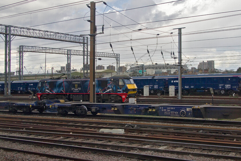 290021, stabled, Wembley Yard 
 Celebrity liveried 90021 Donald Malcom rests between duties in Wembley Yard. The Class 90 was prepared and named almost a year ago in April 2022 to mark the centenary of the founding of Malcom Group (as it is known today) in a tie-up with DB Cargo. This is the first time that I have photographed this locomotive for some years with it being a regular performer on the southern WCML during its time working for Virgin West Coast hauling the Pretendolino set and for ScotRail working the sleepers. 
 Keywords: 290021 stabled Wembley Yard Donald Malcom