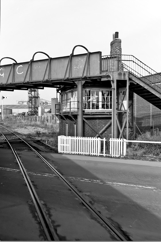 North Ormesby Signal Box (NER, date not known) 
 North Ormesby signal box had an unusual design that is partially visible in this photograph taken from a passing Class 101 DMU. It was located where North Ormesby Road crossed the railway at a level crossing in Middlesborough. When the A172 and A66 relief roads were constructed in the late 1980s the whole scene here was changed and the level crossing abandoned. On removal of the footbridge the odd roof shape to accommodate it was revealed. The signal box was in use until late 1990 when the new roads were opened. It is not visible here but this level crossing had a set of the electrical wheel boom level crossing gates that were unique to the north and northeast. Studying Google Earth, the remnants of the level crossing and bridge that crossed the small stream running behind the box can be clearly seen. 
 Keywords: North Ormesby Signal Box North Eastern Railway NER