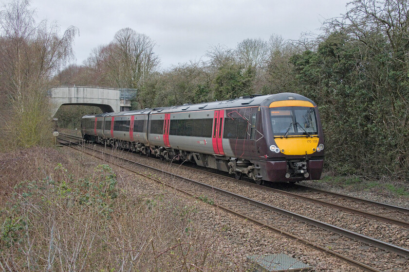 170106, XC 09.52 Birmingham New Street-Leicester (1K09, RT), Elmesthorpe SP471958 
 The 09.52 Birmingham New Street to Leicester CrossCountry service passes the village of Elmesthorpe between Hinckley and Narborough. I am standing atop some concrete steps that straddle a fence at a rare thing, a public foot crossing. The sighting of trains from this direction was not very good given the proximity of the road bridge that carries the B581 over the railway. This nearly caught me out when I arrived with a train from this same direction catching me unawares as I was crossing with the driver giving me an additional blast on the horn! 
 Keywords: 170106 09.52 Birmingham New Street-Leicester 1K09 Elmesthorpe SP471958 CrossCountry Turbo