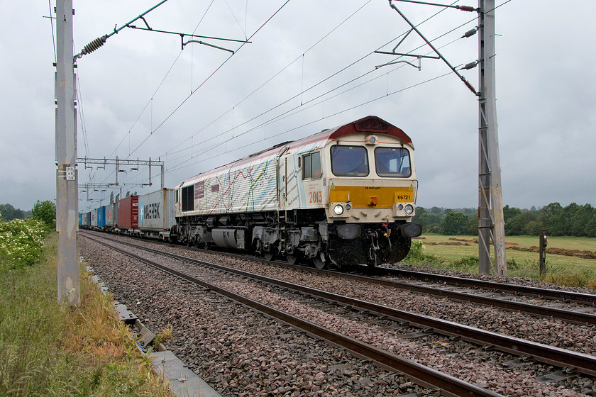 66721, 08.12 Birch Coppice-Felixstowe North (4L29), Wilson`s crossing 
 66721 'Harry Beck' brings the 4L29 08.12 Birch Coppice to Felixstowe North Freightliner past Wilson's crossing north of Northampton. The weather was appalling with a cold wind blowing and driving rain; the things we do in pursuit of our hobby! This GBRf locomotive has certainly brightened up the dull scene resplendent in its one-off livery showing part of the tube network map as created by Harry Beck after whom it is named 
 Keywords: 66721 08.12 Birch Coppice-Felixstowe North 4L29 Wilson`s crossing