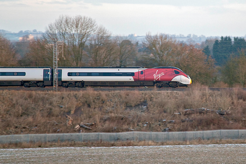 390115, VT 06.35 Manchester Piccadilly-London Euston (1A06, 1E), Bugbrooke SP673563 
 390115 speeds southwards past the Northamptonshire village of Bugbrooke forming the 1A06 06.35 Manchester Piccadilly to Euston. This embankment has been opened up since Network Rail cleared it last year creating a new photo opportunity. 
 Keywords: 390115 06.35 Manchester Piccadilly-London Euston 1A06 Bugbrooke SP673563