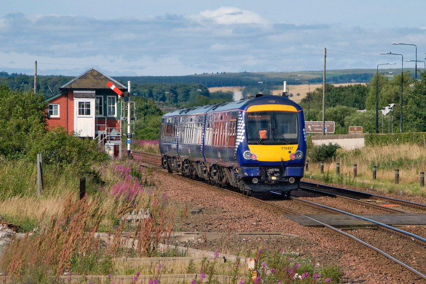 170457, SR 13.41 Glasgow Queen Street-Aberdeen (1A67), Montrose station 
 170457 gets away from Montrose station passing the North signal box with the 13.41 Glasgow Queen Street to Aberdeen working. It's shame that I have not positioned the train better so that it was between the two signal posts one of which is partially obscured behind the rear of the train. I think that it would just about have fitted between that post and the box! However, I like the lighting in this image, something that we enjoyed during the second half of this day touring the railways of northeast Scotland. 
 Keywords: 170457 13.41 Glasgow Queen Street-Aberdeen 1A67 Montrose station ScotRail