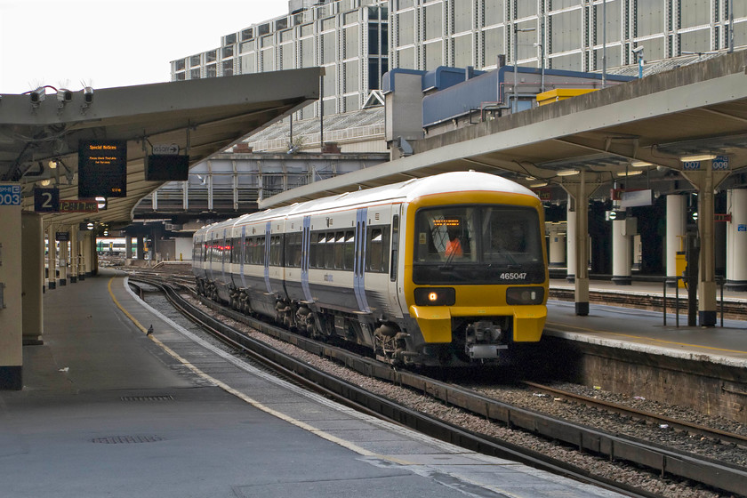 465047, SE 11.36 Orpington-London Victoria (2D56), London Victoria station 
 A South Eastern Networker arrives at Victoria station. 465047 works into platform three with the 11.36 2D56 from Orpington. I was not permitted access to the platforms at Victoria but the gateline for the short platform one is a fair way along platform two. The ticket inspector was more than happy for me to take pictures from her gateline as long as I did not take any of the staff or security equipment. However, with regard to the latter, I should think that it would be pretty impossible to take a picture at Victoria that would not have a security camera in it, note just the three pointing in my general direction for starters! Also, notice the Network SouthEast click-clack clock still in operation on platform two showing the correct time. 
 Keywords: 465047 11.36 Orpington-London Victoria 2D56 London Victoria station Networker