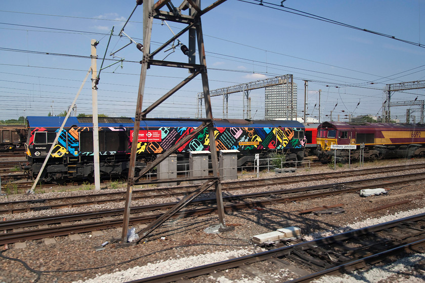 66718 & 66192, stabled, Wembley Yard 
 66718 'Sir Peter Hendy CBE' in its bright London Transport Museum livery sits stabled in Wembley yard. 66192 is parked up just in front of it. 66718 received this livery and was named in October 2103. Sir Peter Hendy was a former chairman of both Network Rail and Transport for London. 
 Keywords: 66718 66192 Wembley Yard