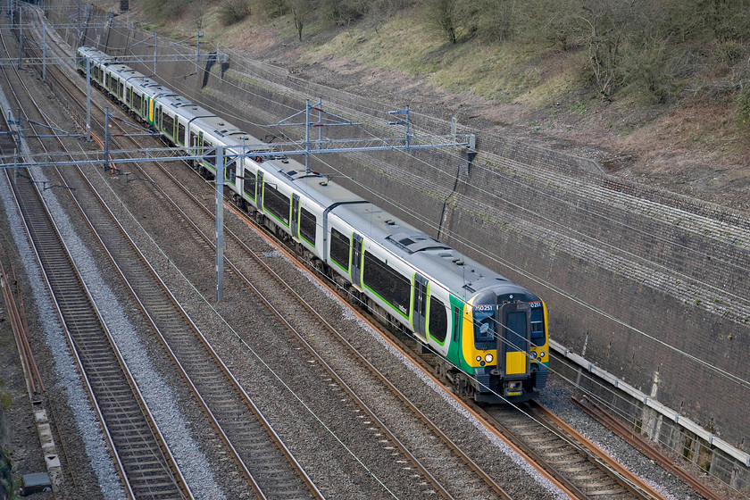 350251, LM 15.54 Birmingham New Street-London Euston (2Y14), Roade cutting 
 A pair of London Midland Desiros led by 350251 passes through Roade cutting working the 15.54 Birmingham New Street to London Euston train. Close examination of the secondman's cab window reveals a perfect reflection of the bridge on which I am standing and going in even further using Photoshop reveals me standing taking the photograph over the parapet! 
 Keywords: 350251 15.54 Birmingham New Street-London Euston 2Y14 Roade cutting London Midland Desiro