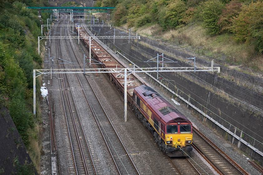 66085 & 66063, 12.00 Fenny Stratford-Bescot up engineering sidings (6R06), Roade cutting 
 66063 is dragged along at the rear of the 6R06 12.00 Fenny Stratford to Bescot engineering train. The wagons are conveying used concrete sleepers from a worksite on the Marston vale line for recycling at Network Rail's vast Bescot infrastructure facility. 
 Keywords: 66085 66063 12.00 Fenny Stratford-Bescot up engineering sidings 6R06 Roade cutting EWS