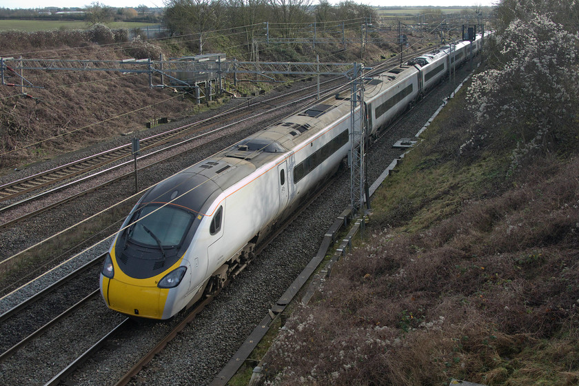 2. 390008, VT 11.20 London Euston-Manchester P (1H21, 3L), Victoria bridge 
 390008 'Charles Rennie Mackintosh' passes Victoria bridge just south of Roade in south Northamptonshire forming the 11.20 Euston to Manchester Piccadilly. The eponym of 390008 has a link close to this location. Charles Rennie Mackintosh did work for local resident and businessman Wenman Joseph Bassett-Lowke, founder of the model train manufacturer Bassett-Lowke. He had a house in the nearby village of Roade that Mackintosh did work on and also owned the nearby 78 Derngate in Northampton that Mackintosh completely re-designed that can be visited and enjoyed today having been lovingly restored, see..... https://www.78derngate.org.uk/index.html 
 Keywords: 390008 11.20 London Euston-Manchester Piccadilly 1H21 Victoria bridge Avanti West Coast Pendolino Charles Rennie Mackintosh