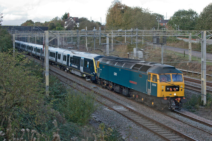 47749 & 701035, 10.00 Derby Litchurch Lane-Wimbledon Park Depot (5Q90, 54L), site of Roade station 
 Taking the up fast line past the site of Roade's former station GBRf's 47749 'City of Truro' leads the 10.00 Derby Works to Wimbledon depot service with SWR's brand new 701035 in tow. This train was running extremely late and was booked to go via Northampton but unusually signallers decided it could travel via the Weedon route perhaps to gain some time. Despite this, it still arrived at its desination nearly an hour late. 
 Keywords: 47749 701035 10.00 Derby Litchurch Lane-Wimbledon Park Depot 5Q90 site of Roade station City of Truro South Western Railway