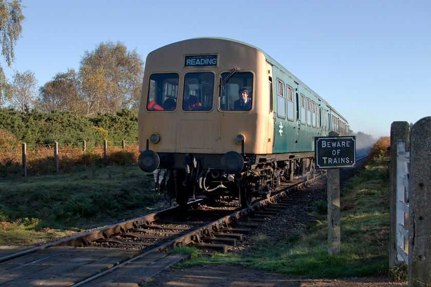 M51188 & M56352, 09.55 Sheringham-Holt, Kelling Heath 
 Leaving a cloud of exhaust in its wake, the 09.55 Sheringham to Holt DMU service completes its climb of Kelling Bank crossing the heath at Windpump crossing. The DMU is composeed of two class 101 cars from different sets. The BR blue car is M51188 on loan from the Ecclesbourne Valley Railway. The rear car is M56652, in British Railways green, is on a long-term loan agreement from the National Railway Museum. 
 Keywords: M51188 M56652 09.55 Sheringham-Holt Kelling Heath