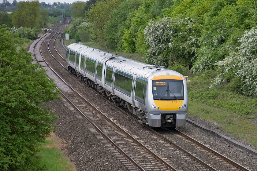 168113, CH 09.06 London Marylebone-Birmingham Moor Street (1R17), Hardwick Farm bridge SP463429 
 Travelling at walking pace hot on the heels of a railtour that had just passed is 168113 working the 09.06 Marylebone to Birmingham Moor Street. The train is seen a short distance north of Banbury about to pass under an occupation bridge just adjacent to the very noisy M40 motorway. 
 Keywords: 168113 09.06 London Marylebone-Birmingham Moor Street 1R17 Hardwick Farm bridge SP463429 Chiltern Railways Turbo