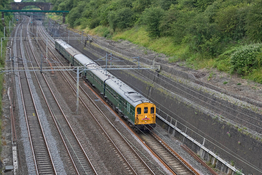 1001, return leg of The Hastings Diesel's Crewe, 17.16 Crewe-Hastings (1Z07), Roade cutting 
 Having travelled to Crewe in the morning Thumper 1001 returns packed with enthusiasts through Roade cutting. The vintage DEMU was running as 1Z07 (hence the headcode numerics) leaving Crewe at 17.16 to return to its home base at Hastings. Rather oddly when this photograph was taken there appeared to be an issue with its horn with it blowing softly and almost continually making for a very odd soundtrack as it passed through the depths of the cutting! 
 Keywords: 1001 The Hastings Diesel's Crewe 17.16 Crewe-Hastings 1Z07 Roade cutting Hastings Diesel Thumper DEMU