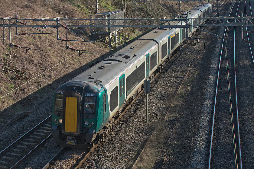 350254, LN 12.24 London Euston-Rugeley Trent Valley (2H65, RT), Victoria bridge 
 A London Northwestern operated Desiro, in one of their three livery variants, passes Victoria bridge just south of Roade in Northamptonshire. 350254 is forming the 12.24 London Euston to Rugely Trent Valley 2H65 service. 
 Keywords: 350254 12.24 London Euston-Rugeley Trent Valley 2H65 Victoria bridge London Northwestern Desiro