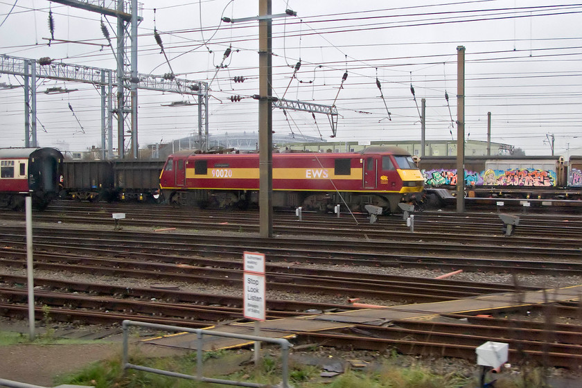 90020, stabled, Wembley Yard 
 With Wembley stadium in the background 90020 'Collingwood' sits idle in Wembley yard awaiting its next duty. This locomotive is always characterised by its odd white EWS and number graphics that have become increasingly faded over the years. 
 Keywords: 90020 stabled Wembley Yard Collingwood