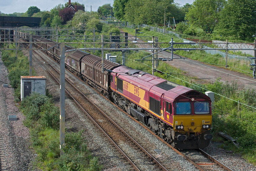 66169, 11.15 Ditton Foundry-Dollands Moor (6O26, 1L), site of Roade station 
 Still wearing its 'as-built' but long defunct EWS paint scheme 66169 passes the site of Roade's former station working the 11.15 Ditton to Dollands Moor service. This now weekday daily service makes a pleasant change from the more usual run-of-the-mill Freightliner trains that pass this location day in and day out! 
 Keywords: 66169 11.15 Ditton Foundry-Dollands Moor 6O26 site of Roade station EWS