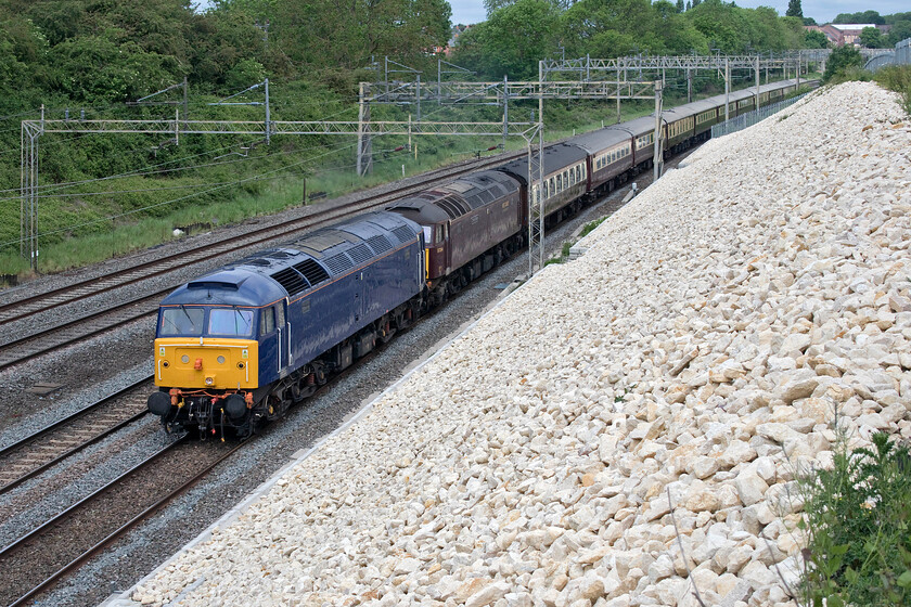 47812 & 57314, outward leg of The Northern Belle, 07.18 Manchester Victoria-London Victoria (1Z60, 25L), Ashton Road bridge 
 Running some forty minutes late The Northern Belle 07.18 Manchester Victoria to London Victoria charter passes just south of Roade. The charter was supposed to have been top and tailed throughout and this was the case on leaving Manchester. However, after an undisclosed problem at Stoke-on-Trent it appears that 47812 that was on the rear was run round the train after 57314 'Conwy Castle' was failed. After leaving Stoke some forty minutes late, it had made up a good deal of time on reaching London just twenty-five minutes adrift. I must admit that photographing a double-headed train is preferable to one in top and tailed mode. 
 Keywords: 47812 57314, outward leg of The Northern Belle, 07.18 Manchester Victoria-London Victoria 1Z60 Ashton Road bridge Conwy Castle