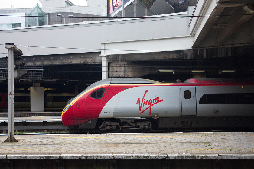 390153, VT 12.50 Birmingham New Street-London Euston (1B46, 2E), Birmingham New Street station 
 390153 'Mission Accomplished' pokes its nose into the daylight at Birmingham New Street waiting to work the 12.50 to London Euston. This 1B46 working takes about an hour and a half depending on the stopping pattern. When HS2 opens, the journey will be down to 50 minutes. 
 Keywords: 390153 12.50 Birmingham New Street-London Euston 1B46 Birmingham New Street station