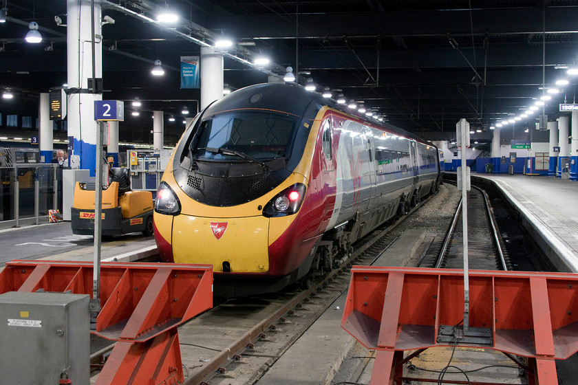 390117, VT 19.07 London Euston-Liverpool Lime Street (1F26, 10L), London Euston station 
 Becoming increasingly less common is a Pendolino in its as-built livery as Virgin make progress turning them out in their flying silk paint scheme. Here, 390117 'Virgin Prince' waits to leave Euston with the 1F26 19.07 to Liverpool Lime Street. 
 Keywords: 390117 1F26 London Euston station