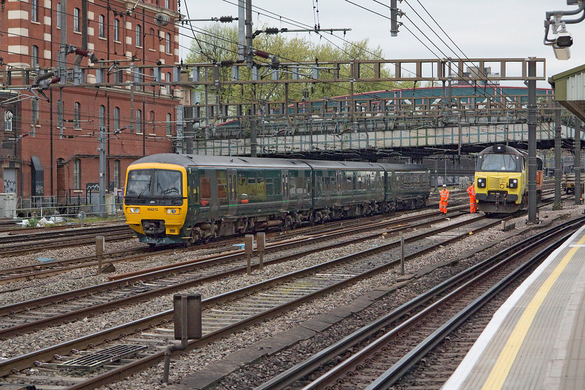 166212, GW 14.01 Oxford-London Paddington (1P49, 2L) & 70807, stabled, Royal Oak LU station 
 Three -car 166212 drifts past Royal oak station working the 14.01 from Oxford to Paddington. It's passing 70807 stabled in connection with bank holiday engineering works that are taking place within the confines of Paddington station. 
 Keywords: 166212 1P49 70807 Royal Oak LU station