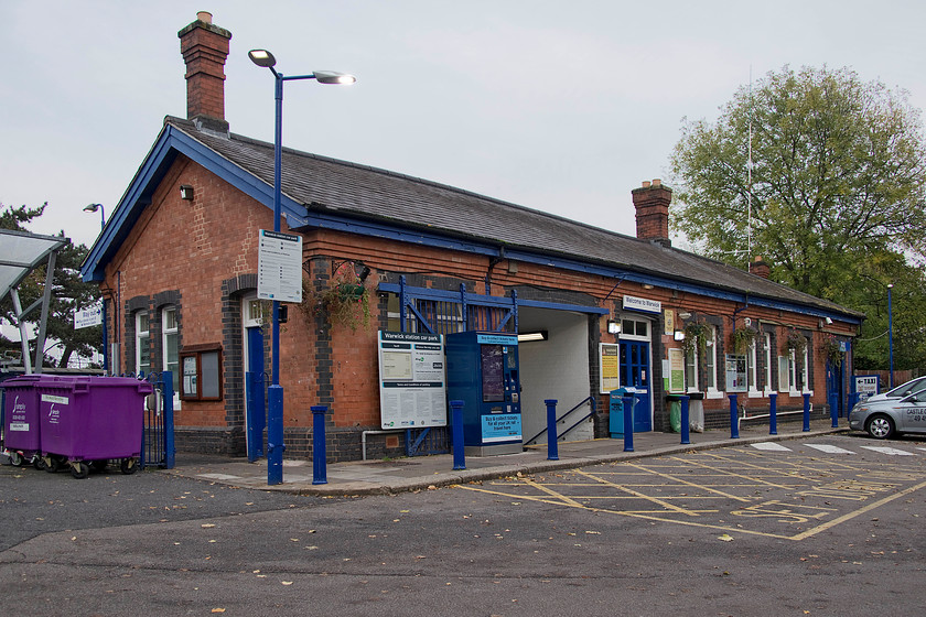 Frontage, Warwick station 
 Warwick station was opened by the GWR in 1852. It's a relatively simple station building with a pedestrian tunnel, seen in the centre of the frontage, giving access to the up platform. I took a very similar photograph to this in December 1985 with the building looking very almost the same apart from some different paint colours. Then, there was a 'B' registered Talbot Solara parked where the bins are in this image! 
 Keywords: Frontage Warwick station