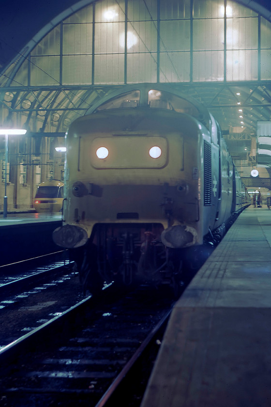 55015, 21.00 London King`s Cross-Edinburgh (1S66), London King`s Cross station 
 Before our late night drive home from London to the West Country, Graham and I paid a quick visit to King's Cross. We found two Deltics at the station, the first being 55015 'Tulyar' at the head of the SO 21.00 1S66 to Edinburgh. It was a tricky photograph to take as I had to pop off the platform end and it is taken looking back into the light of the station. Notice the HST sitting in a platform to the left. This Deltic is still with us today and, at the time of writing, thanks to the incredible hard work of the Deltic Preservation Society, will be operating again after a long restoration. 
 Keywords: 55015 21.00 London King`s Cross-Edinburgh 1S66 London King`s Cross station