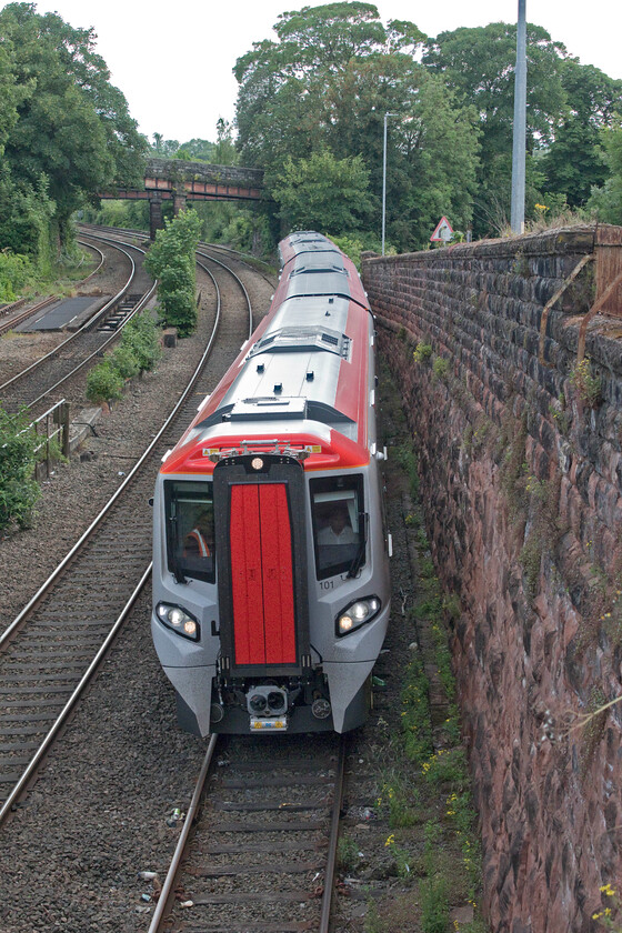 197101, 17.35 LlandudnoJunction-Crewe (cancelled from Chester) (3K52, 42E), Raymond Street 
 Testing times for new stock! 197101 is seen approaching Chester taken from the city's Raymond Street bridge working the 3K52 Llandudno to Crewe mileage accumulation turn. The Class 197s will soon operate all over the northwest and become a familiar sight replacing all of the Coradia Class 175s and the Express Sprinter Class 158s. In the background of this view two of the bridges that carry the city wall over the railway can be seen. These were constructed in 1848 to carry the railway from Chester onwards to North Wales; can one imagine today merely knocking through a historic city wall in this way? 
 Keywords: 197101 17.35 LlandudnoJunction-Crewe 3K52 Raymond Street