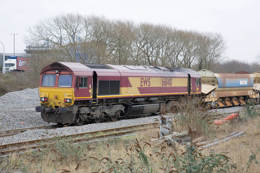 66148, ballast train, Bescot Yard 
 66148 stands at the rear of an infrastructure train in Bescot Yard taken from the platform of Bescot Stadium station. The station takes its name from the nearby Banks's Stadium that is the home to Walsall FC. 
 Keywords: 66148 ballast train Bescot Yard