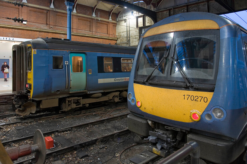 156407 LE 16.45 Norwich-Sheringham & 170270, LE 16.40 Norwich-Great Yarmouth, Norwich station 
 A pair of Greater Anglia units rest against the blocks at Norwich station. To the left 156407 will work the 16.45 to Sheringham whilst to the right 170270 will leave first as the 16.40 to Great Yarmouth. My wife, son and I would travel back to the coast on 156407. 
 Keywords: 156407 16.45 Norwich-Sheringham 170270 16.40 Norwich-Great Yarmouth Norwich station GA Greater Anglia