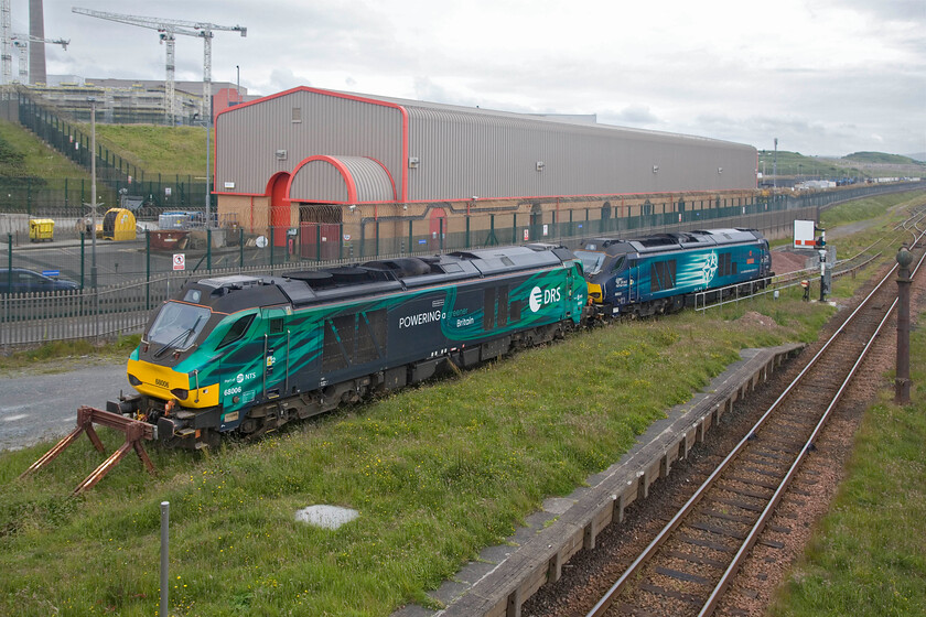 68006 & 68033, stabled, Sellafield station 
 68006 'Pride Of The North' and 68033 'The Poppy' stand awaiting their next duty in a siding next to Sellafield station. A small part of the huge reprocessing facility is seen behind the locomotives with the ever-present cranes supporting its incessant development and growth! It is the associated freight traffic and the large number of workers who get to and from the facility by train that has probably kept the Cumbrian Coast line open. 
 Keywords: 68006 68033 stabled Sellafield station Pride Of The North The Poppy