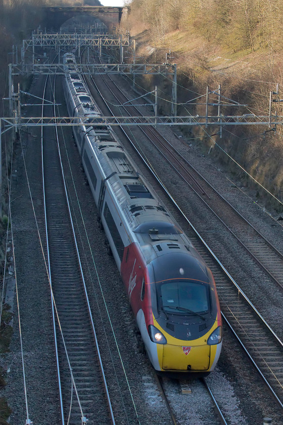 390040, VT 14.30 Birmingham New Street-London Euston (1B37, 2L), Hyde Road bridge 
 390040 is about to exit the southern end of Roade Cutting under Hyde Road bridge with the 14.30 Birmingham New Street to Euston train. It won't be many weeks now until the afternoon sun is able to illuminate trains in the cutting. 
 Keywords: 390040 14.30 Birmingham New Street-London Euston 1B37 Hyde Road bridge