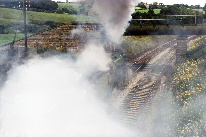 4472, outward leg of The North Yorkshireman, Carnforth-Skipton, Wennington SO625700 
 I did get a bit carried away with my pictures of 4472 'Flying Scotsman' leading The North Yorkshireman away from Wennington but it was such a dramatic departure that I make no apologies! The final picture is a going away photograph with Scotsman lost in the steam and smoke. It was just beginning a continuous twelve-mile section of climbing as far as milepost 237 just north west of Giggleswick. The noise, as well as the sight of this departure, was something to behold and the tape recording that I made remains one of my all-time favourites. 
 Keywords: 4472 The North Yorkshireman, Carnforth-Skipton Wennington SO625700