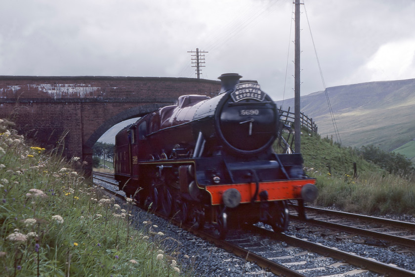 5690, down LE after assisting failed freight at Garsdale, Ais Gill SD773979 
 After assisting an up failed freight near to Garsdale station 5690 'Leander' returns light engine tender first north back to its own train that was abandoned at Kirkby Stephen. 40179 had come to a halt on the approach to Garsdale and with noting ales available control amazingly authorised 5690 to run wrong line to south to get past the stricken train and then haul it to Garsadale into a siding. I stand to be corrected but could this have been the first steam-hauled freight train since 1968 if in slightly odd circumstances? 
 Keywords: 5690 down LE after assisting failed freight at Garsdale Ais Gill SD773979 Leander