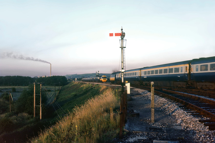 253008, 19.25 London Paddington-Plymouth & 253017, 16.23 Penzance-London Paddington, Hawkeridge East Junction 
 A meeting of HSTs at Hawkeridge East Junction sees the 19.25 Paddington to Plymouth approaching Westbury on the down passing the 16.23 Penzance to Paddington in the foreground. The up HST is set number 253017 that had power cars W43034 and W43035 at either end if it was running in the correct formation. The down service is being worked by 253008 with either W43016 or W43017 leading. Whilst we are still trespassing we have moved back to a much safer position close to the little-used up east chord of Hawkeridge Junction. I will probably have cursed two HSTs at this time seeing them as the scourge of the modern railway but now some forty years later this image is historically very interesting! 
 Keywords: 253008 19.25 London Paddington-Plymouth 253017 16.23 Penzance-London Paddington, Hawkeridge East Junction HST Westbury 43016 43017 43034 43035