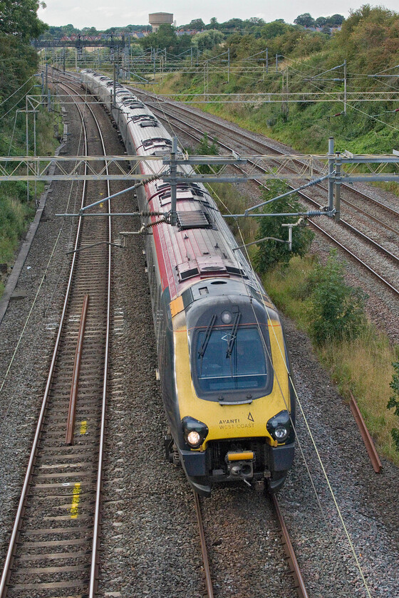 221115 & 221104, VT 16.33 Birmingham International-London Euston (1B52, 6L), Victoria bidge 
 Over a year ago the much-disliked Class 221 Voyagers should have been withdrawn from service on the WCML relieving customers of the dreadful travelling experience that they offer. With the Class 805s (and the all-electric Class 807) that are due to replace them chronically delayed, as is now the norm with new trains, they will see out the end of the year. 221115 leads 221104 past Victoria bridge near Roade working the 16.33 Birmingham International (as opposed to New Street on this day) to Euston service. 
 Keywords: 221115 221104 16.33 Birmingham International-London Euston 1B52 Victoria bridge AWC Avanti West Coast Voyager