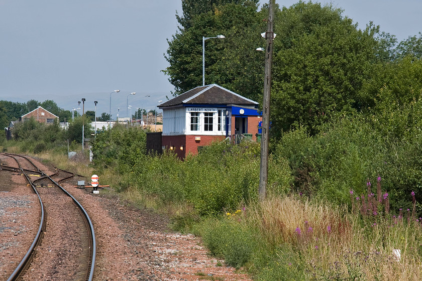 Larbert North signal box (Caledonian, 1892) 
 This is the best view that I could get of Larbert North signal box from the station platform end as Network Rail have built a huge training centre right opposite precluding photographic access. The box is a Caledonian structure dating from 1892 but has undergone various 'improvement' in recent years. The arrival of the electrification masts is imminent along with the resignalling of the line so by 2017 the box will probably be closed. However, with direct access from Muirhall Road behind the box, it would make an ideal caf for the people of Larbert and a perfect viewing spot for enthusiasts whilst they enjoy a coffee and piece of cake! 
 Keywords: Larbert North signal box Caledonian