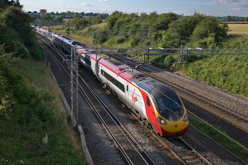 390042, VT 16.47 Liverpool Lime Street-London Euston (1A57), Victoria bridge 
 390042 'City of Bangor/Dinas Bangor' sweeps around a right-hand curve just south of Roade in Northamptonshire working the 16.47 Liverpool Lime Street to Euston 1A57 service. I commented last week on the shabby state of the front end of this particular Pendolino and it is clear to see again in this photograph. This is a bit of a surprise as Virgin tend to make an effort to keep their fleet looking good. 
 Keywords: 390042 16.47 Liverpool Lime Street-London Euston 1A57 Victoria bridge Virgin West Coast Pendolino City of Bangor Dinas Bangor.