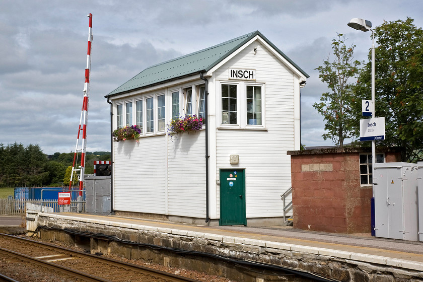 Insch signal box (GNS, 1886) 
 The window boxes do their best to disguise the rather ugly modernisation of Insch signal box! Underneath the UPVC cladding and corrugated roof lies a delightful GNSR Type 2a wooden building opened in 1886 that is fitted with a twenty lever frame. It controls the level crossing and marks the eastern end of the double track section to Kennethmont. 
 Keywords: Insch signal box Great North of Scotland Railway GNS