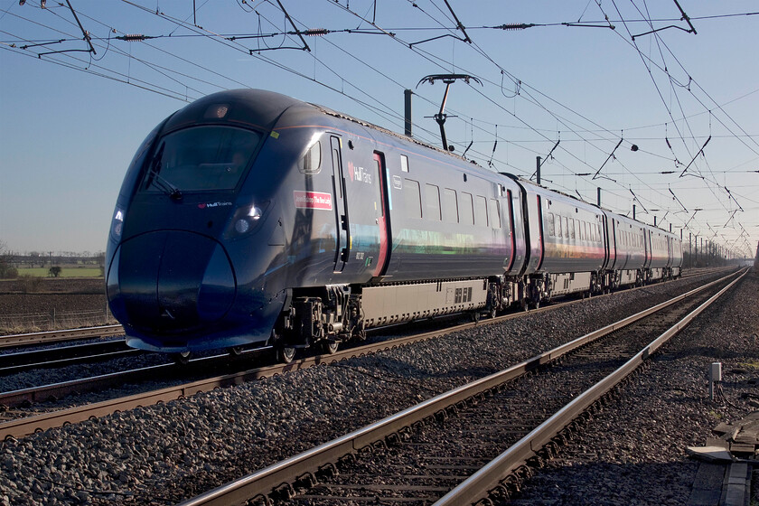 802302, HT 13.48 London King's Cross-Hull (1H04, 7E), Holme Green crossing TL192426 
 There is no doubt that Hull Trains' Class 802 Paragon units look smart and that they have had an impressive livery applied. However, I cannot quite get used to there being no yellow front warning panel! 802302 'Jean Bishop The Bee Lady' passes Holme Green occupation crossing between Arsley and Biggleswadeworking the 1H04 13.48 King's Cross to Hull service. The train is named after the late local (to Hull) celebrity charity fundraiser Jean Bishop who used to wear a bee costume whilst she rattled her collection tin around the city, see.... https://www.bbc.co.uk/news/av/uk-england-humber-42101275 
 Keywords: 802302 13.48 London King's Cross-Hull 1H04 Holme Green crossing TL192426 Hull Trains Paragon Jean Bishop The Bee Lady